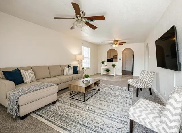 a living room with furniture and a flat screen tv