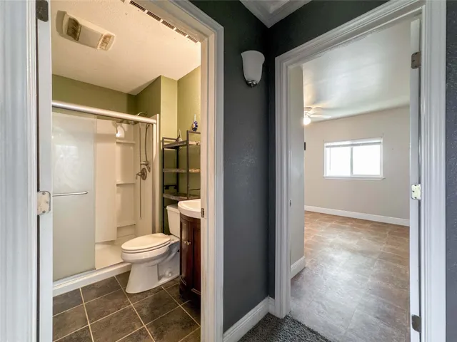a bathroom with a toilet and a shower