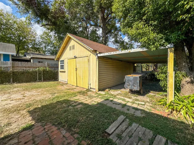a view of backyard of house and garage
