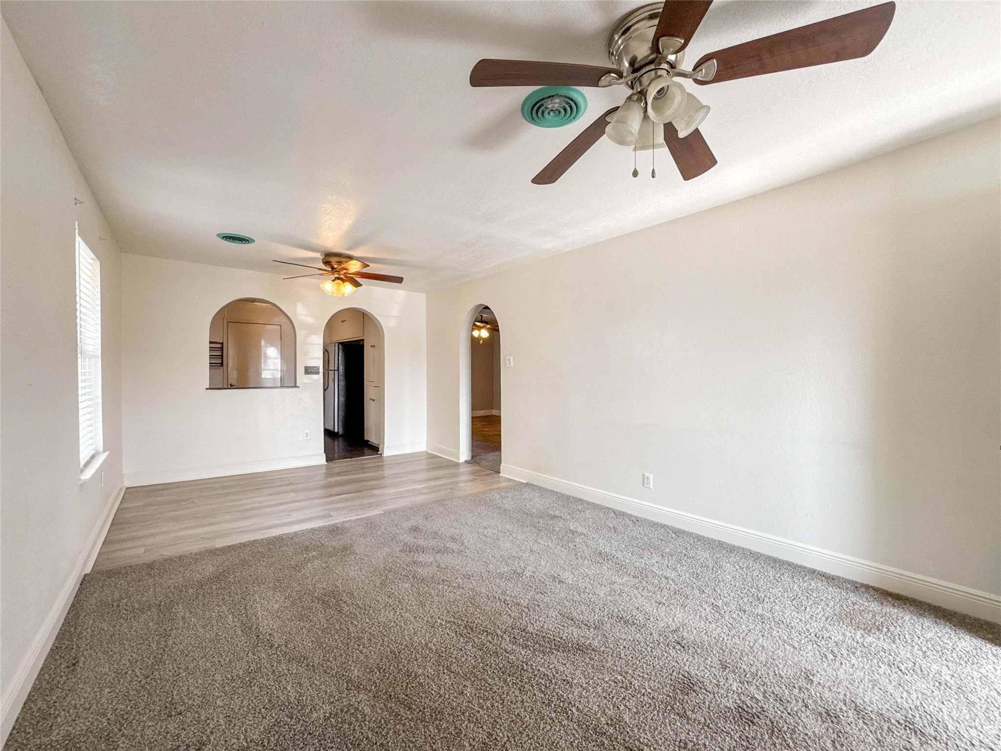 8321 Leander Street Houston, TX 77012 - Photo 3 of 23 a view of a livingroom with a ceiling fan and window