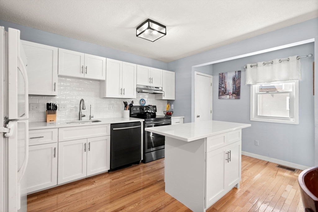 2 Halsey Way, Unit 40C Salem, MA 01970 - Photo 1 of 19 a kitchen with white cabinets stainless steel appliances and sink
