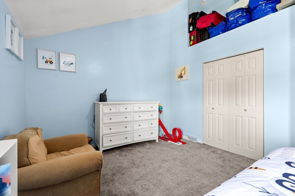 2 Halsey Way, Unit 40C Salem, MA 01970 - Photo 12 of 19 a bedroom with a bed and furniture
