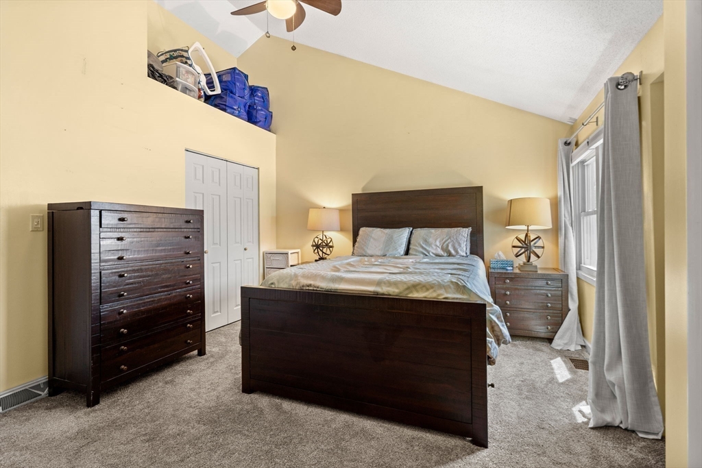 2 Halsey Way, Unit 40C Salem, MA 01970 - Photo 13 of 19 a bedroom with a bed and a mirror