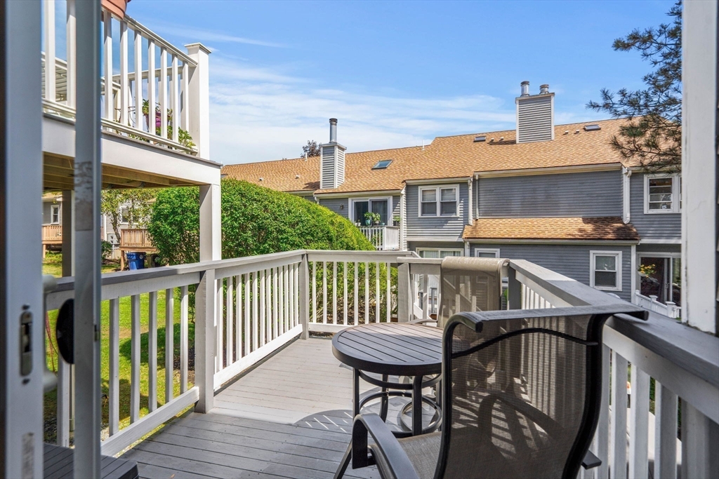 2 Halsey Way, Unit 40C Salem, MA 01970 - Photo 17 of 19 a balcony with a table and chairs