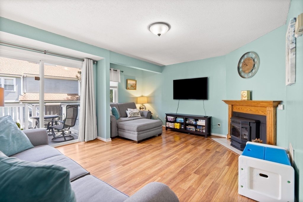 2 Halsey Way, Unit 40C Salem, MA 01970 - Photo 2 of 19 a bedroom with furniture and a fireplace