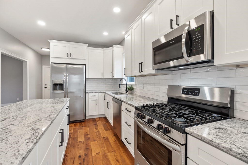 1499 South Athol Road Athol, MA 01331 - Photo 5 of 21 a kitchen with stainless steel appliances kitchen island granite countertop a stove a sink and a microwave