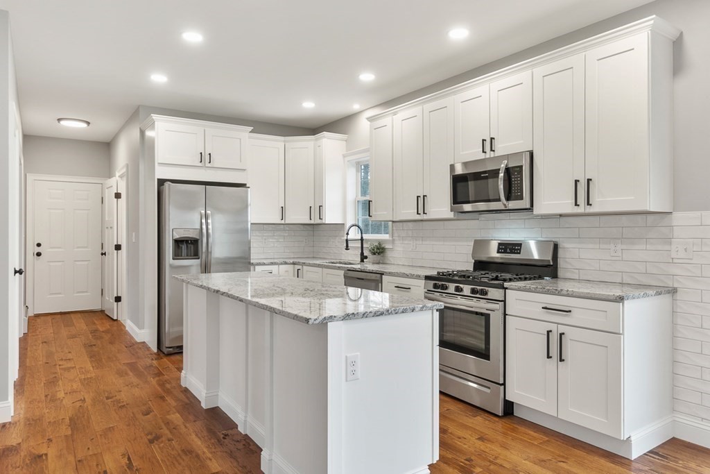 1499 South Athol Road Athol, MA 01331 - Photo 7 of 21 a kitchen with stainless steel appliances granite countertop a stove a sink and a refrigerator