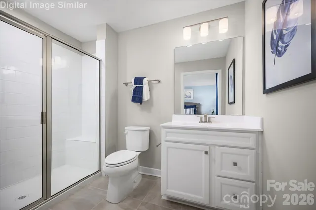 a bathroom with a toilet a sink and a mirror