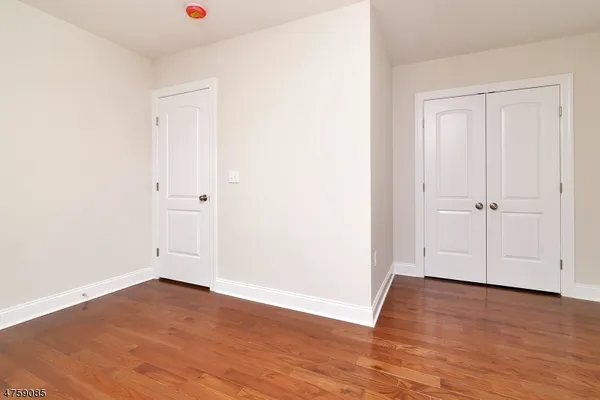 an empty room with wooden floor
