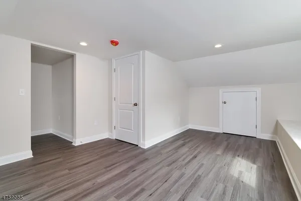 a view of a room with wooden floors