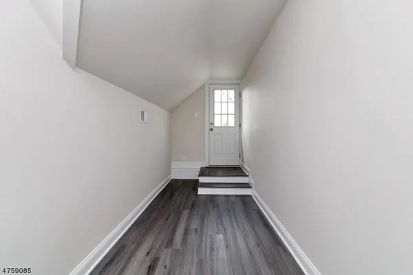 a view of wooden floor and windows in a room