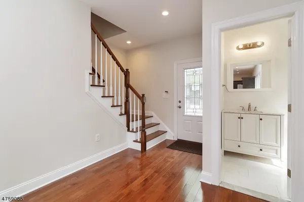 a view of an entryway with wooden floor and staircase