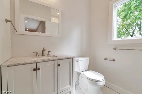 a white toilet sitting next to a bathroom sink