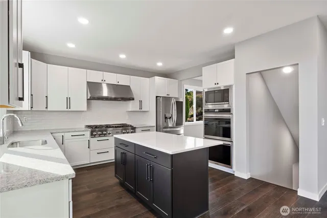 a kitchen with a sink stove and refrigerator
