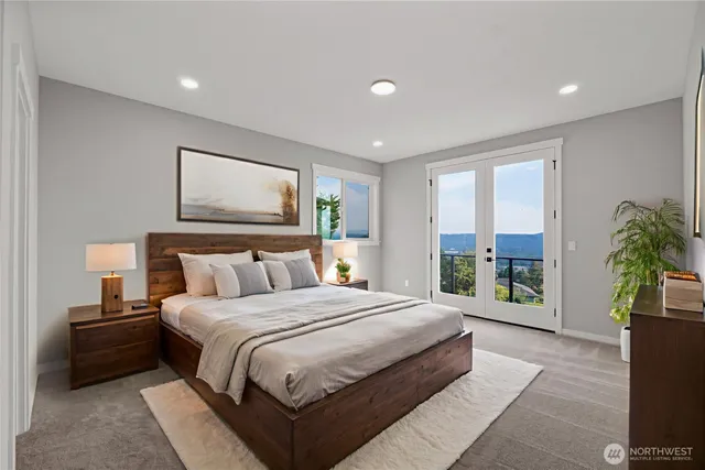 a bedroom with a large bed and a large window