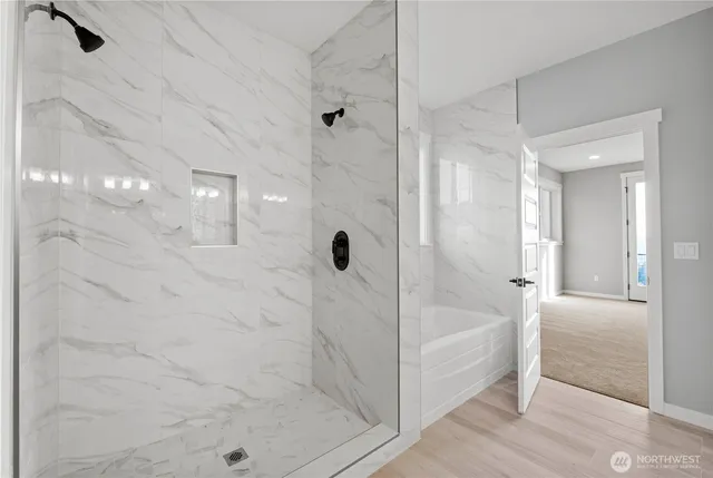 a bathroom with a glass shower door