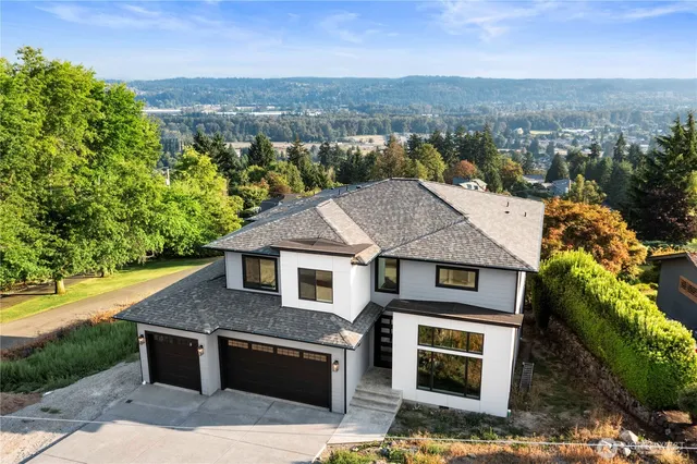 an aerial view of a house with a yard