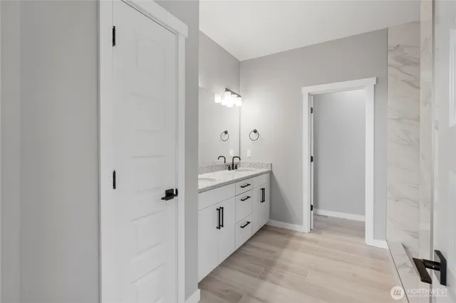 a bathroom with a double vanity sink and mirror