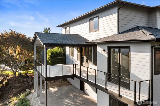 a view of a house with a large window and balcony