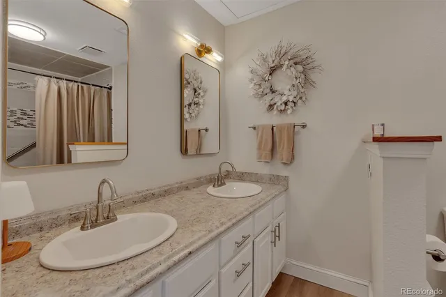a bathroom with a granite countertop sink and a mirror