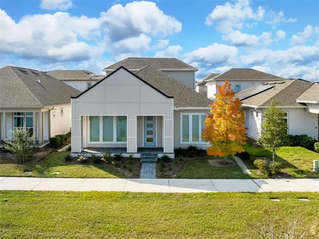 a front view of house with yard and trees around