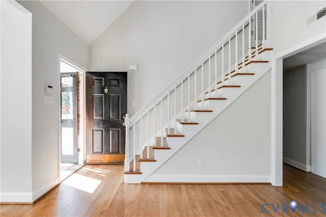 a view of staircase with wooden floor and furniture