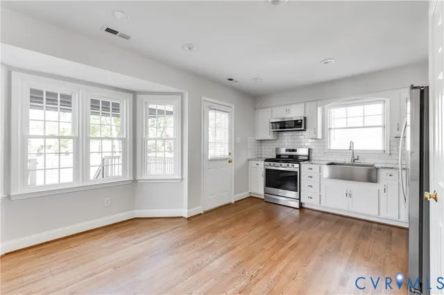 a kitchen with granite countertop a stove top oven and sink