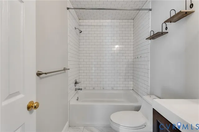 a bathroom with a shower a toilet and bathtub