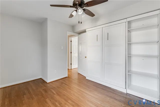 a view of an empty room and wooden floor