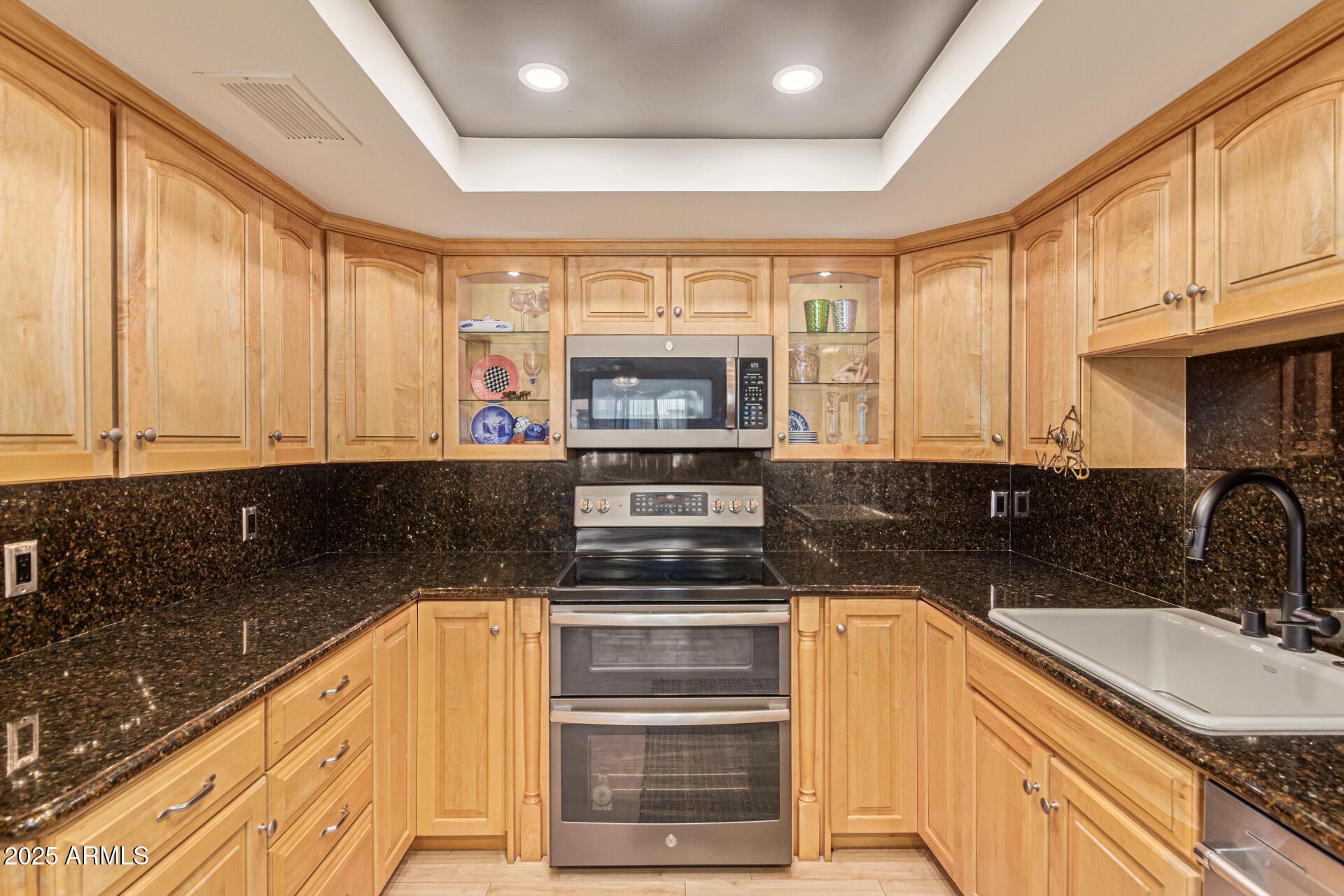 7940 East Camelback Road, Unit 605 Scottsdale, AZ 85251 - Photo 14 of 35 a kitchen with granite countertop a stove sink and cabinets