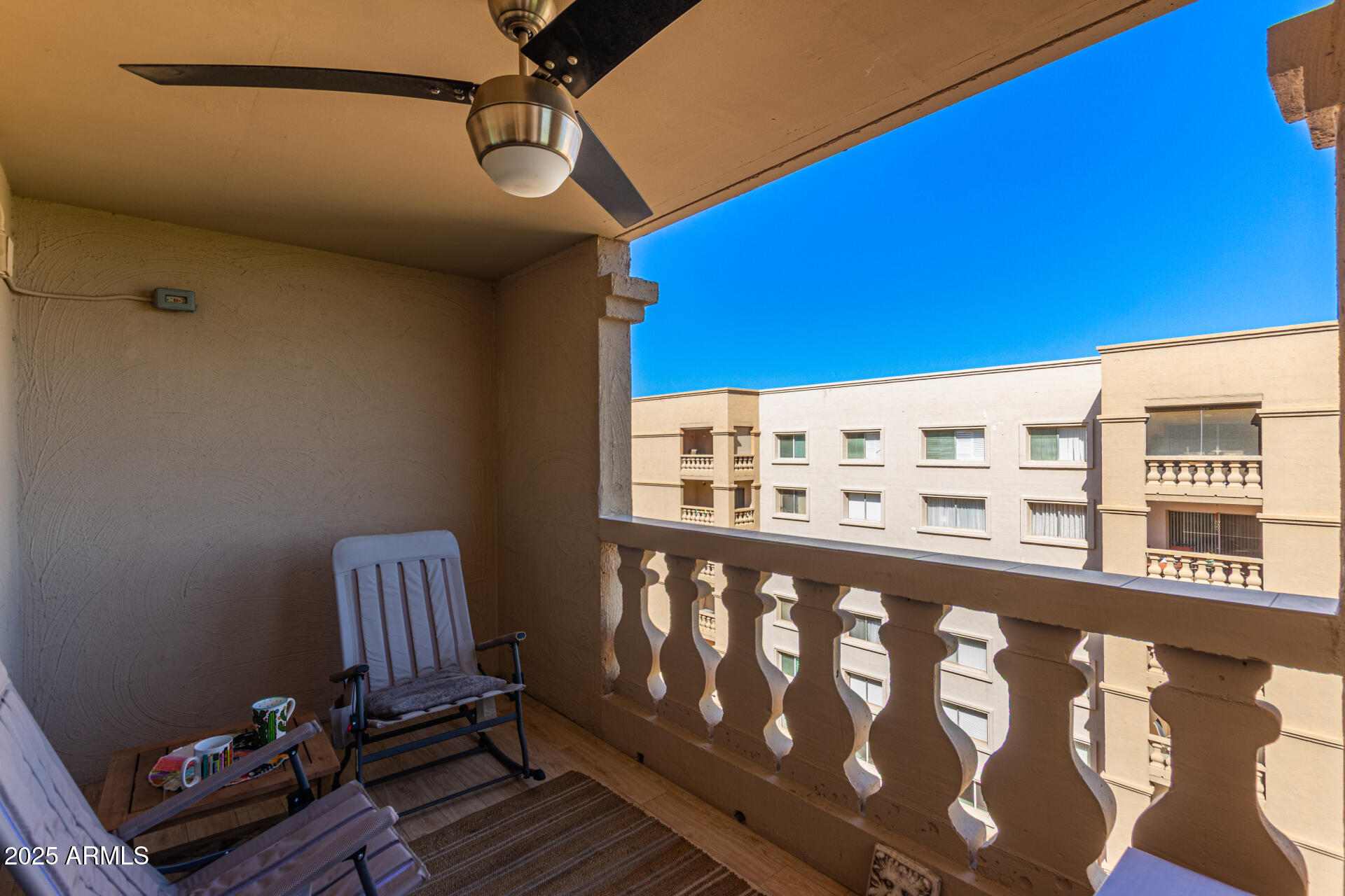 7940 East Camelback Road, Unit 605 Scottsdale, AZ 85251 - Photo 27 of 35 a view of a balcony and wooden benches