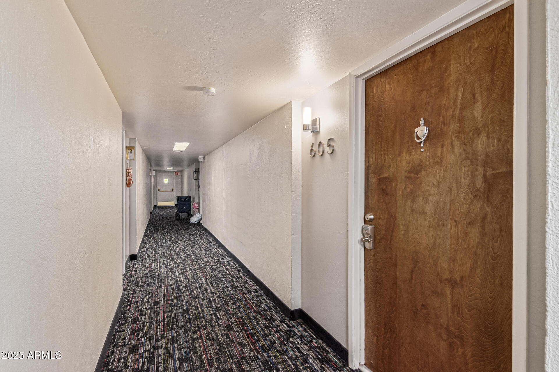 7940 East Camelback Road, Unit 605 Scottsdale, AZ 85251 - Photo 6 of 35 a view of a hallway with wooden floor and a bathroom