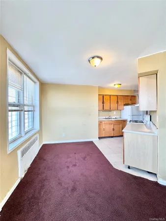 an empty room with fireplace and windows