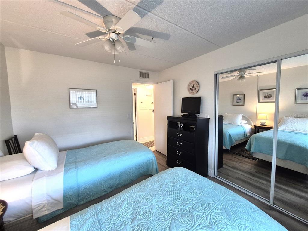 107 Windward Place, Unit 107 Oldsmar, FL 34677 - Photo 27 of 34 a bedroom with a bed and a chandelier
