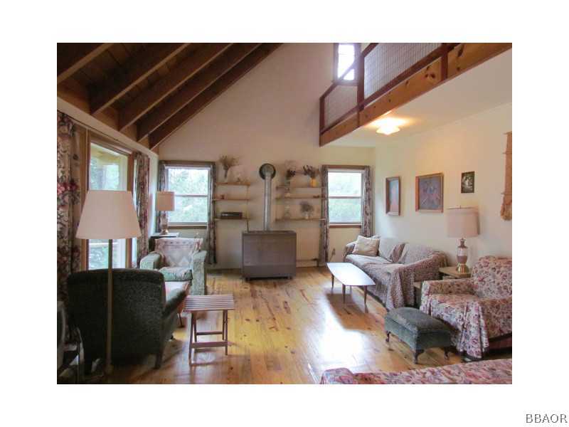 21 Holcomb Valley Road Big Bear Lake, CA 92315 - Photo 2 of 25 a living room with furniture and a fireplace
