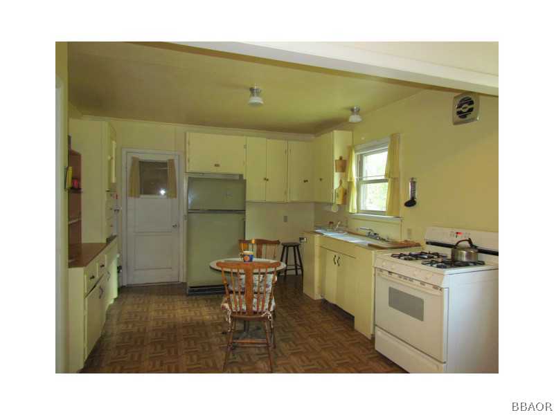 21 Holcomb Valley Road Big Bear Lake, CA 92315 - Photo 5 of 25 a kitchen with a sink appliances and cabinets