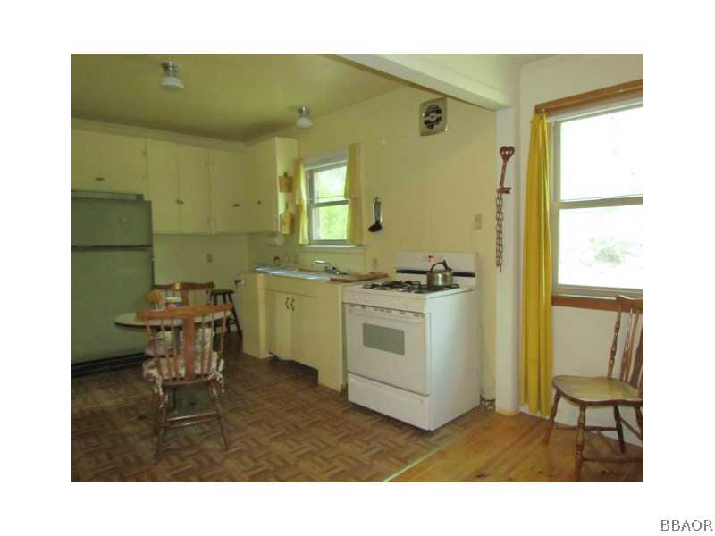 21 Holcomb Valley Road Big Bear Lake, CA 92315 - Photo 6 of 25 a bathroom with a sink a toilet and mirror