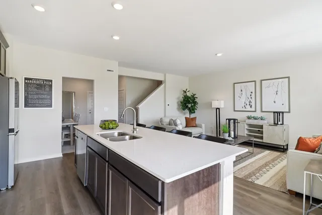 a kitchen that has a lot of cabinets a sink and a stove in it