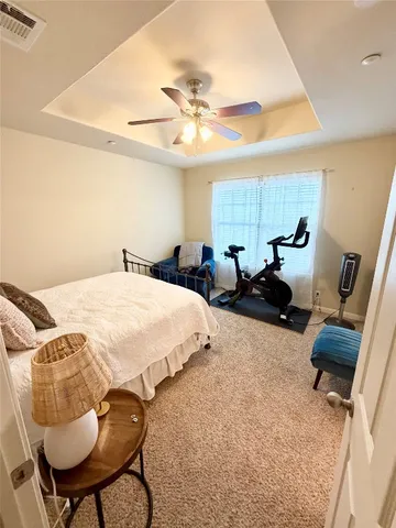 a bed room with two bed and a chair