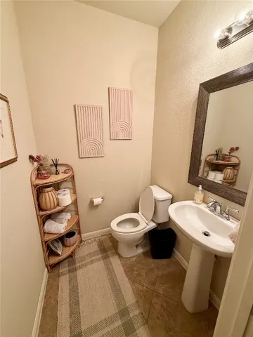 a bathroom with a sink toilet and mirror