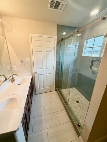 a bathroom with a sink a toilet and shower