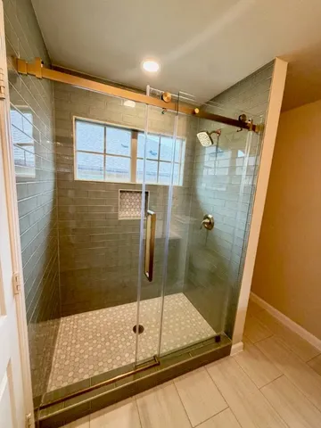 a bathroom with a shower and a sink