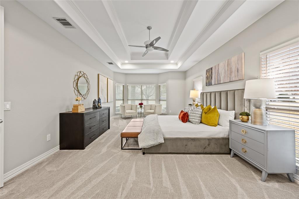 10409 Countryside Drive Denton, TX 76207 - Photo 23 of 38 Bedroom featuring light colored carpet, a ceiling fan, and a tray ceiling