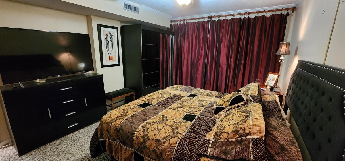 2 Dondanville Road, Unit 216 St. Augustine, FL 32080 - Photo 13 of 23 a bedroom with a bed and flat screen tv