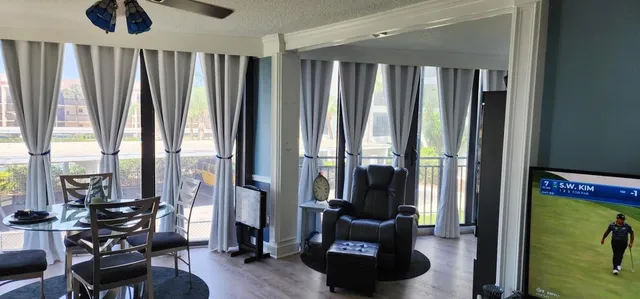 a view of hallway with furniture and a large window