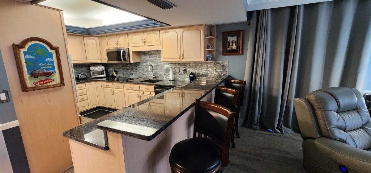 2 Dondanville Road, Unit 216 St. Augustine, FL 32080 - Photo 7 of 23 a kitchen with stainless steel appliances granite countertop a refrigerator a stove top oven a sink and dishwasher