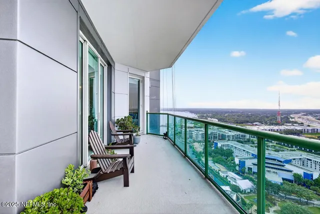 a view of a porch with chairs and backyard