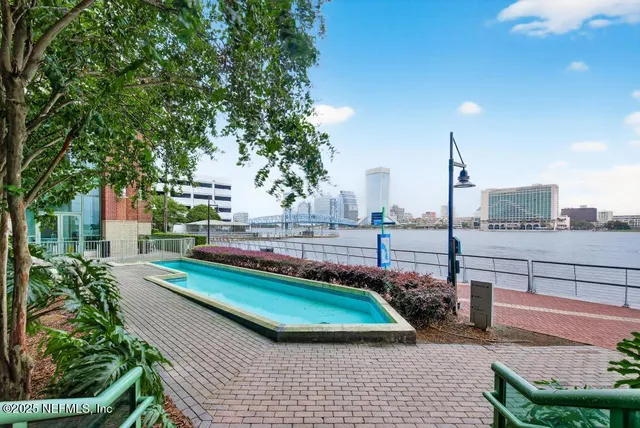 a living room with furniture pool table and a large window