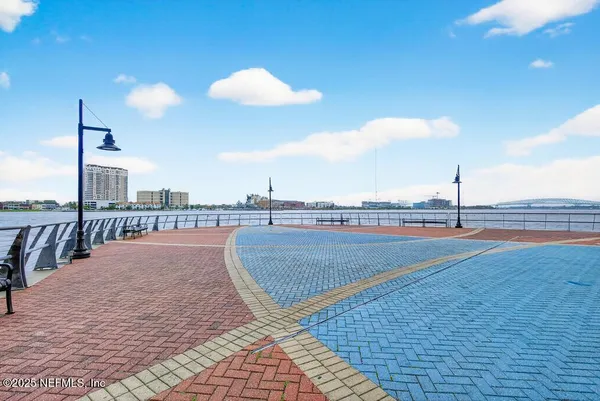 a living room with furniture a flat screen tv and a large window