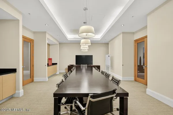a view of a a dining room with furniture window and wooden floor